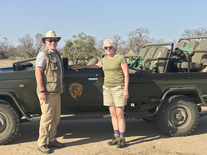couple in front of safari jeep 